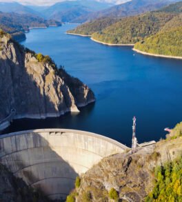 Aerial drone view of Vidraru dam in Romania Aerial drone view of nature in Romania. Valley in Carpathian mountains with Vidraru dam and lake, slopes with lush forest