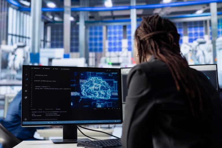 Engineer developing AI algorithms on PC in solar panel plant, training models to predict equipment failures. Technician integrating machine learning solutions to enhance production efficiency